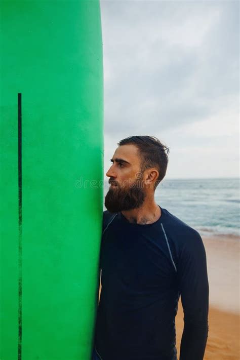 Happy Guy In Beachwear Holding A Surfboard Surfer Back View Looking