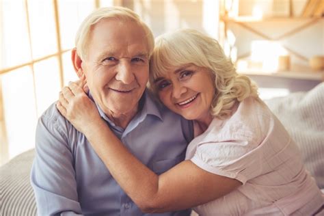 premium photo beautiful old couple is hugging looking at camera