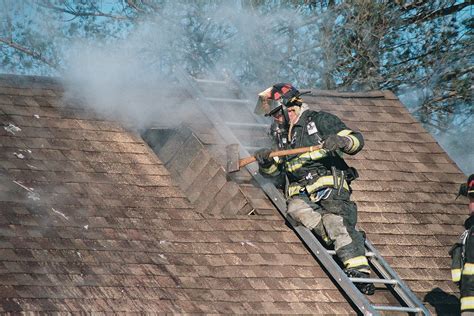 Venting The Roof A Firefighter Vents The Roof As Crews Bat Flickr
