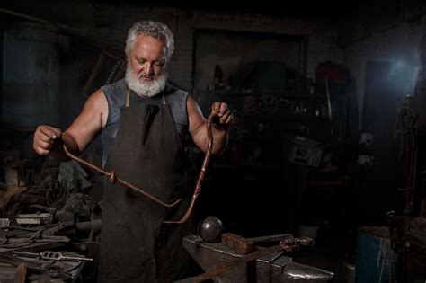 Premium Photo Blacksmith Preparing To Work Metal On Anvil