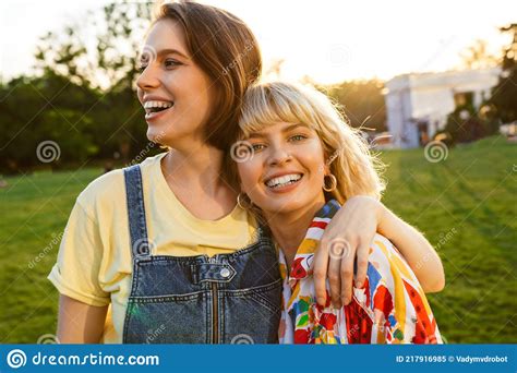 Image Of Cheerful Two Women Laughing And Hugging While Walking Stock Image Image Of Hugging