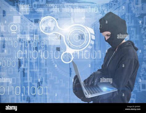 Woman Hacker With Hood Using A Laptop In Data Center Stock Photo Alamy