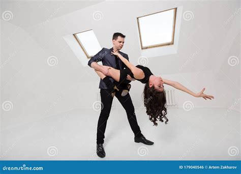 Beautiful Couple Dancing Bachata On White Background In Studio Stock