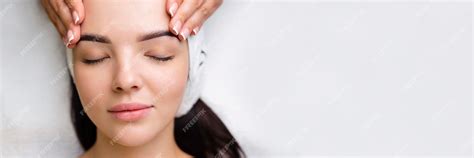 Premium Photo Professional Antiaging Facial Massage Action Relaxing Facial Treatment At Spa