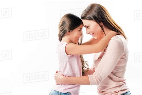 Daughter And Mother Hugging And Looking At Each Other Isolated On White
