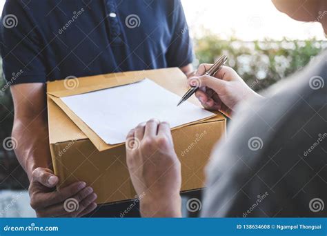 Delivery Mail Man Giving Parcel Box To Recipient Young Man Signing