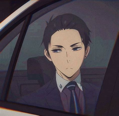 A Man In A Suit And Tie Sitting In A Car With His Head Out The Window