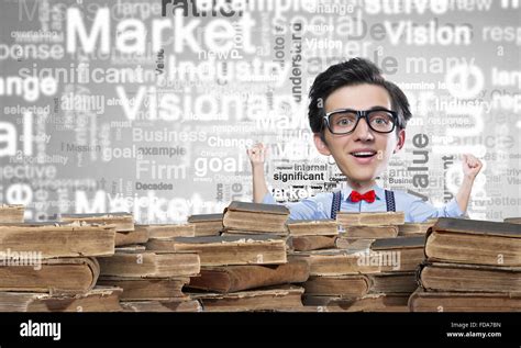 Young Funny Man In Glasses With Big Head Among Pile Of Old Books Stock