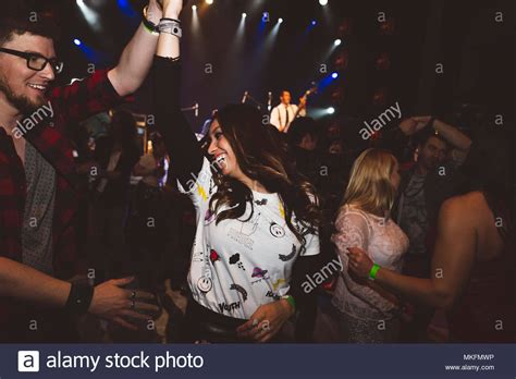 Playful Young Millennial Couple Dancing Partying In Nightclub Stock