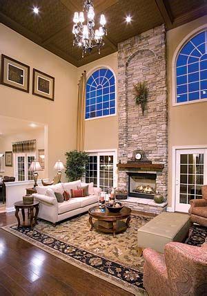 In the case of living rooms with high ceilings the windows usually go all the way up and this makes the interior much brighter than usual. stone fireplace, incredibly high ceilings, spacious living ...