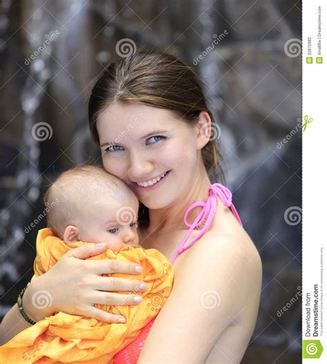 Beautiful Young Mother Is Holding Baby Girl Outside Near Pool Stock