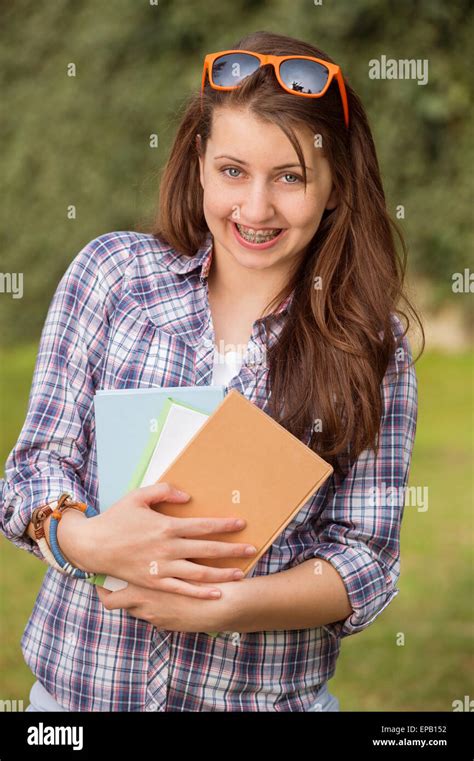 Happy Student With Braces Holding Books Outside Stock Photo Alamy