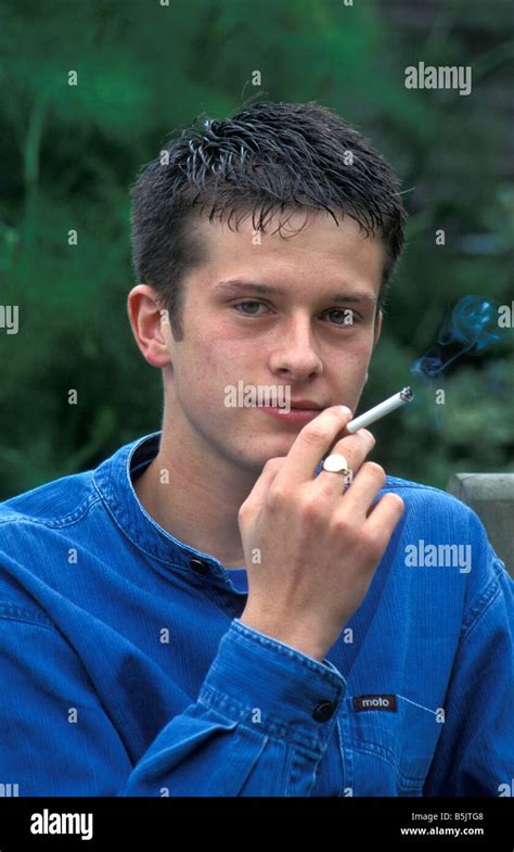 Teenage Boy Smoking Cigarette Stock Photo Alamy