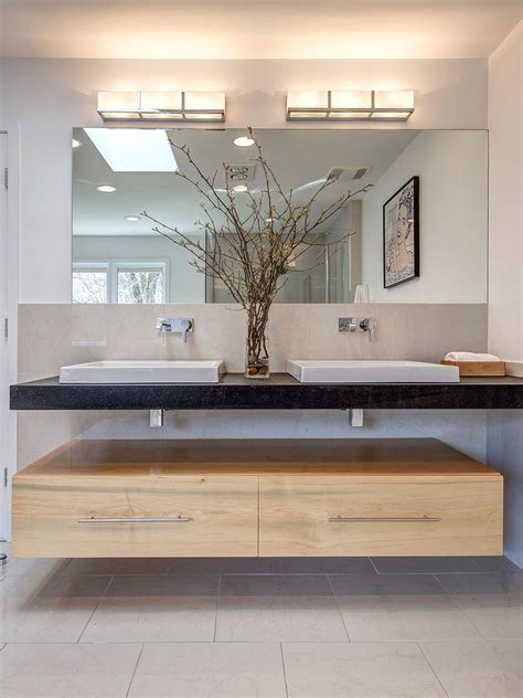 This modern master bath in seattle features a dual sink, marble counter and floating vanity. Photo Page | HGTV