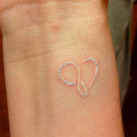 38 White Ink Heart Tattoo On Wrist