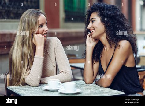 Two Friends Talking Together In Sidewalk Cafe Stock Photo Alamy