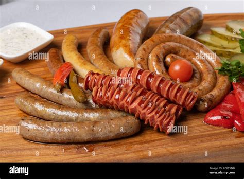 Grilled Sausages Platter With Pickled Cherry Tomatoes Sauce Stock