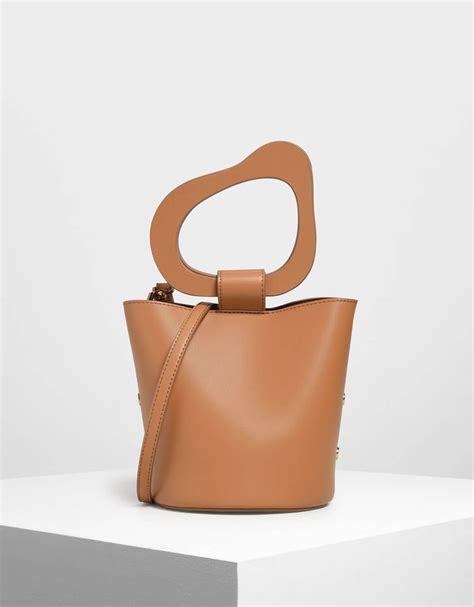 Free shipping with charles & keith on orders over £50. Charles & Keith Tan Sculptural Handle Bucket Bag | Shorts ...