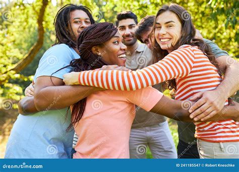 Group Of Young People Stand In A Circle And Hug Each Other Stock Image