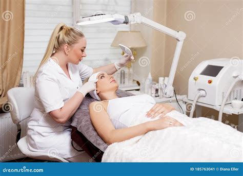Cosmetologist Working With Beautiful Woman In Beauty Salon Stock Image