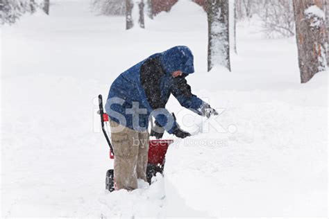 Snowblower Young Man Digging Snow Drifts During Blizzard Storm Stock