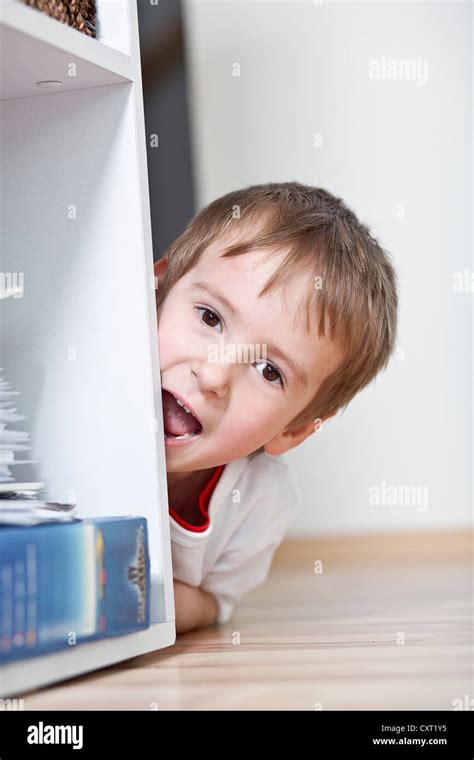 Boy Hiding Behind Shelf Hi Res Stock Photography And Images Alamy