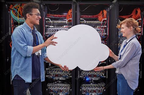 Cloud computing facilitates the access of applications and data from any location worldwide and from any cost savings; IT technicians holding cloud , cloud computing - Stock ...