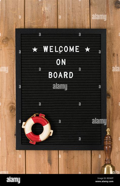 Welcome On Board Phrase Written On Black Felt Message Board With White