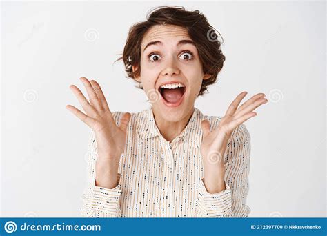 Young Happy Woman Scream Surprised And Amazed Looking Astonished At Something Awesome Shouting