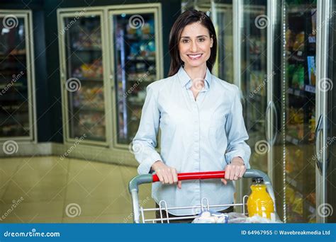 Smiling Woman Pushing Trolley In Aisle Stock Image Image Of Cart
