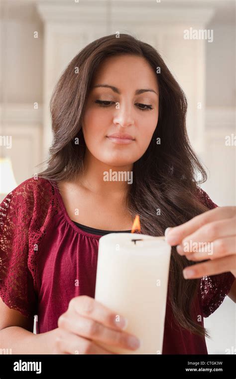 Mixed Race Woman Lighting Candle Stock Photo Alamy