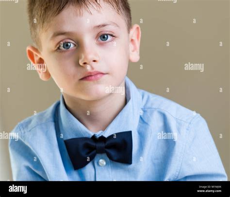 Six Years Old Boy Preparing For His First Day Of School In Blue Shirt