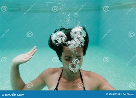 Young Woman Diving Underwater In A Pool Summer And Fun Lifestyle Stock