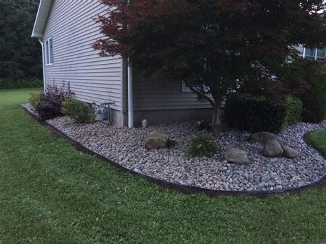 From my pictures of landscape designs series this photo shows a very simple yet attractive planting for in front of a low porch. Removed old mulch, added fresh landscape paper and edger ...