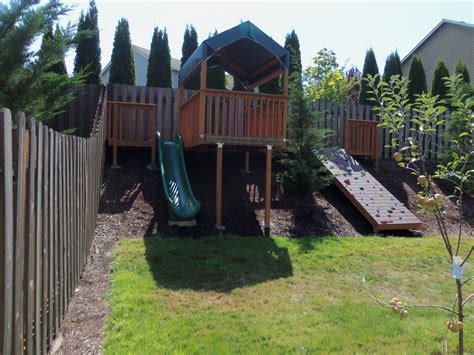 Backyard Hillside Rock Wall Slide And Play Area Sloped Backyard
