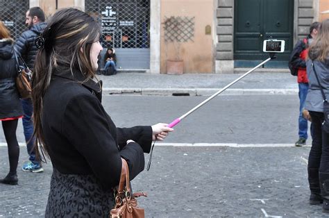 Person Taking A Selfie With Selfie Stick In The Streets Of Rome Italy