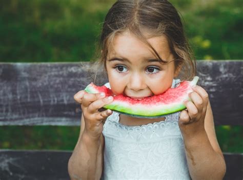 Premium Photo Child Eating Watermelon In The Garden Kids Eat Fruit