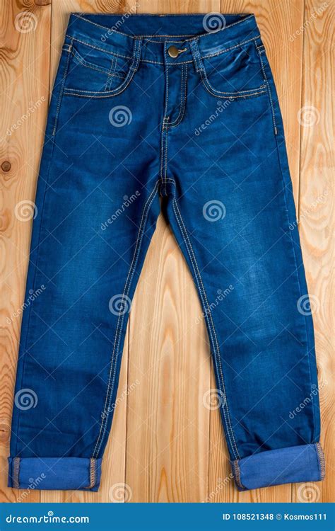 Dark Blue Jeans For A Boy On A Wooden Floor Stock Photo Image Of Desk