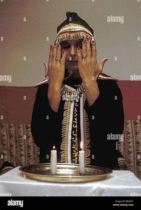 Woman Covers Her Eyes As She Blesses The Shabbat Candles It Is A Custom Not To Look At The