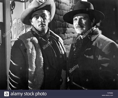 Mitchum plays drifter cowboy jim garry. Robert Mitchum and Robert Preston / Blood on the Moon ...
