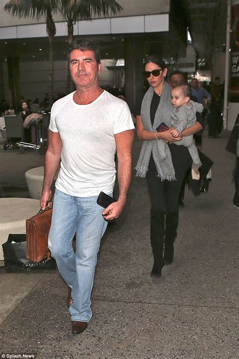 simon cowell leads girlfriend lauren silverman and son eric through lax airport daily mail online