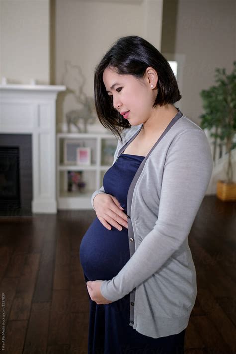 Pregnant Asian Woman At Home By Take A Pix Media