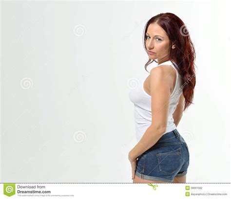 Curvy Redheaded Woman In Tank Top And Shorts Stock Photo