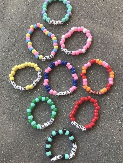 Six Bracelets With Words On Them Sitting On The Ground