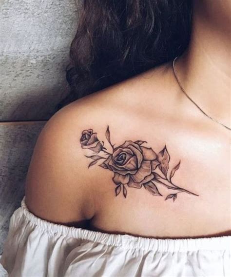 A Woman S Shoulder With A Rose Tattoo On The Left Side Of Her Chest