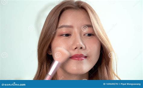 Closeup Asian Beauty Woman Applying Foundation Powder With Brush On Her Face Close Up Process