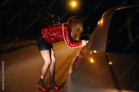 Street Prostitute Talking To Potential Customer In The Car Stock Photo