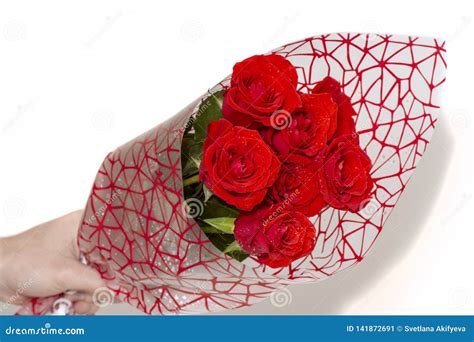 Hand Holding Bouquet Of Red Roses Over White Background Stock Image