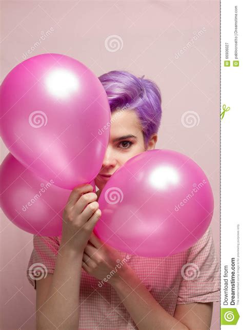 Violet Short Haired Woman In Pink Pastel Smiling Behind Balloons Stock