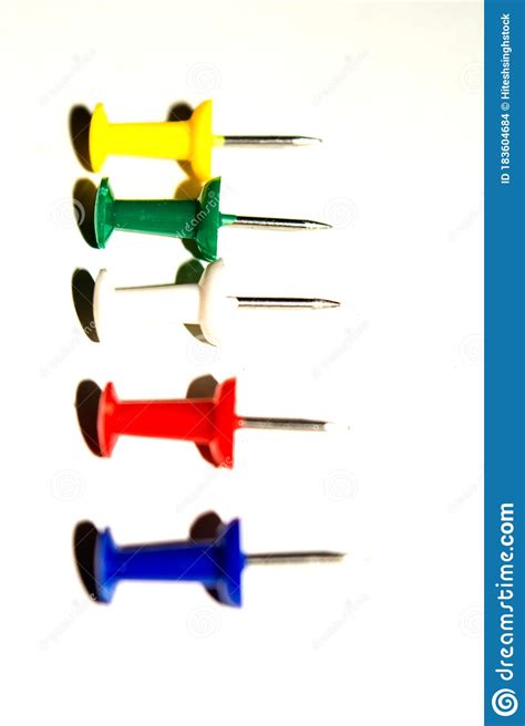 Push Pins And Paper Clips In Different Colors Isolated On White